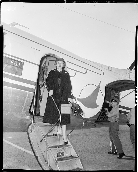 Woman exiting an airplane