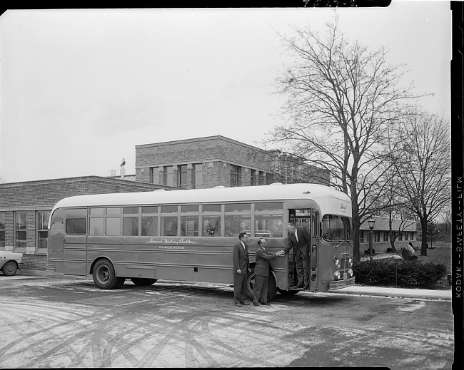 Businessmen outside show bus