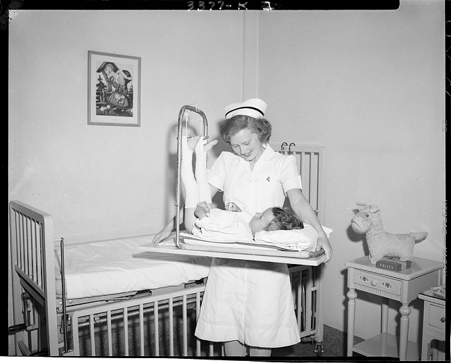 Nurse with child on orthopedic frame