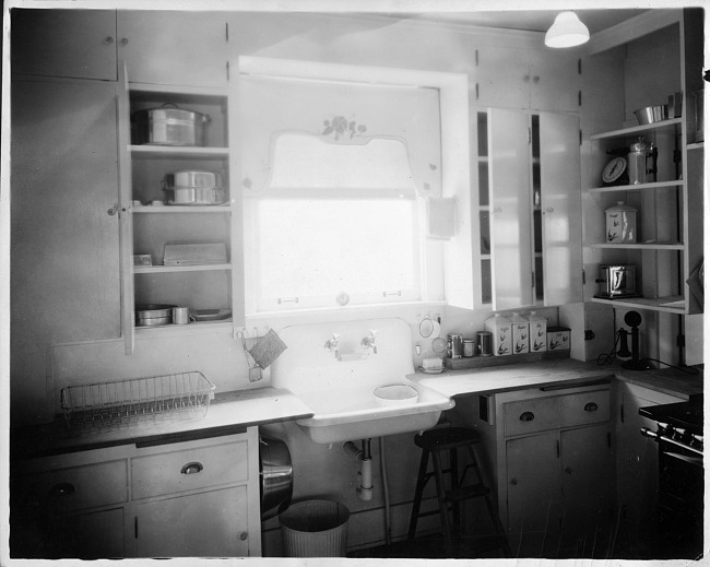 Kitchen interior with sink, window and cupboards, photograph