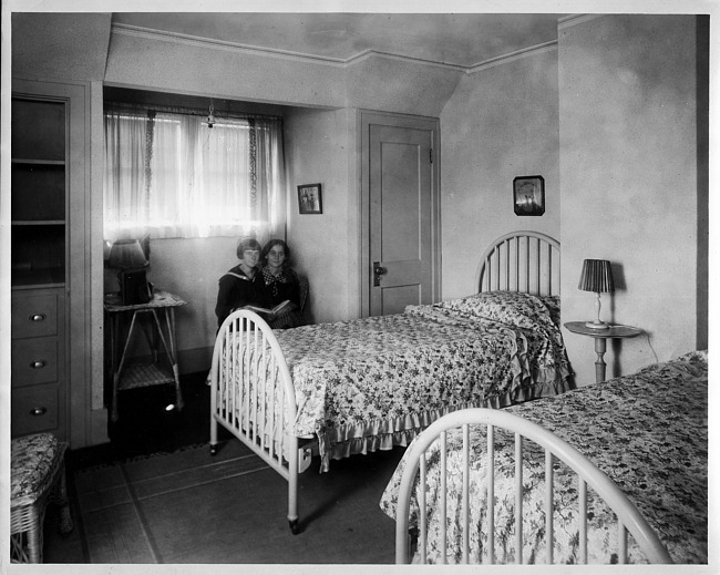 Two young girls in bedroom, photograph