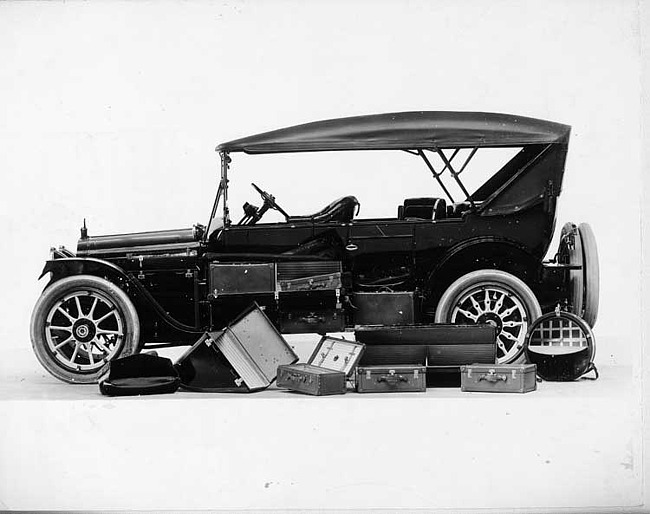 1916 Packard 1-25 touring car, left side, top raised, with several travel trunks