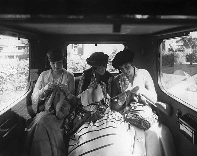 1918 Packard brougham, view from front seat of back seat with three female passengers knitting