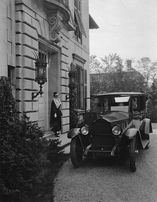 1920 Packard sedan, on drive in front of stone home