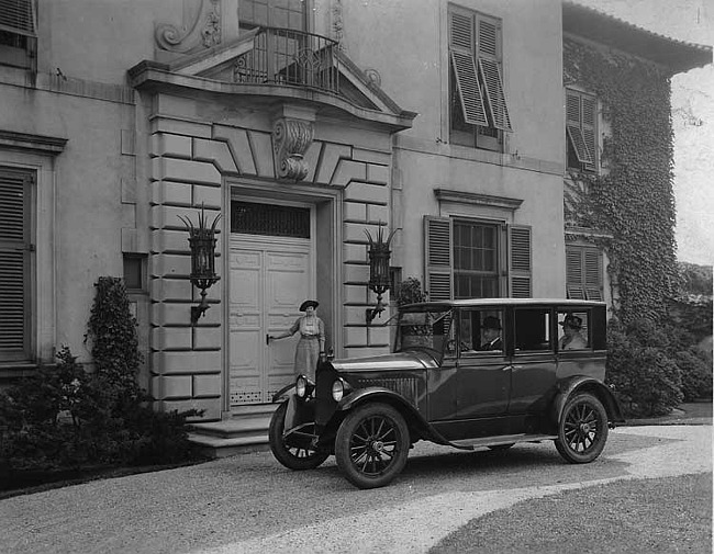 1921-1922 Packard sedan, parked on driveway in front of stone residence