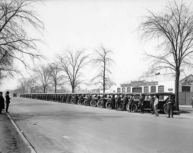 1920-1923 Packard touring cars, parked in front of Packard used car dealership