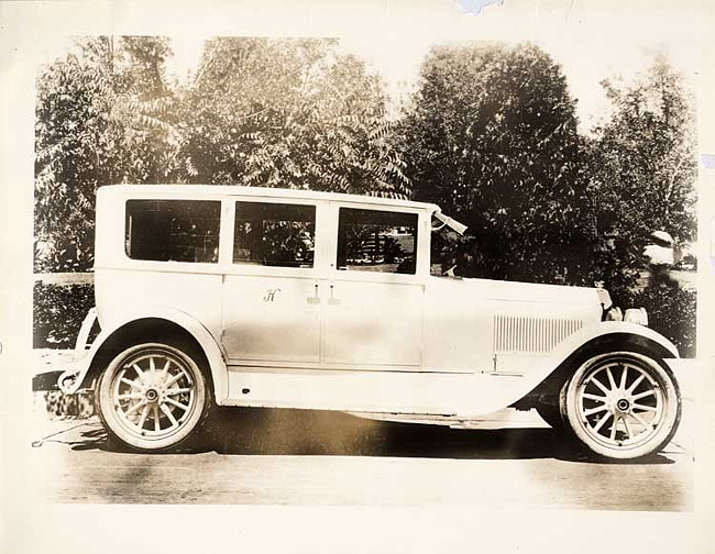 1924 Packard sedan, right side view, parked on street, 'H' on monogram panel