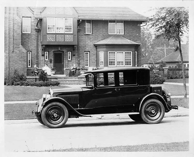 1925 Packard left side view, parked on residential street, in front of large brick home