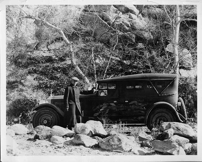 1925-1926 Packard touring sedan on country road, top raised, side curtains in place