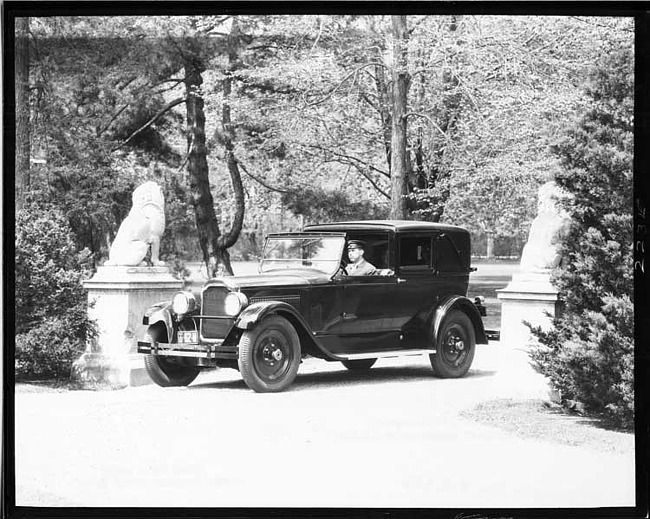 1925-1926 Packard stationary town cabriolet, three-quarter left front view, driven by male chauffeur