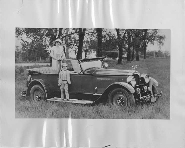 1925 Packard Model 236 sport parked in field, small boy standing on running board