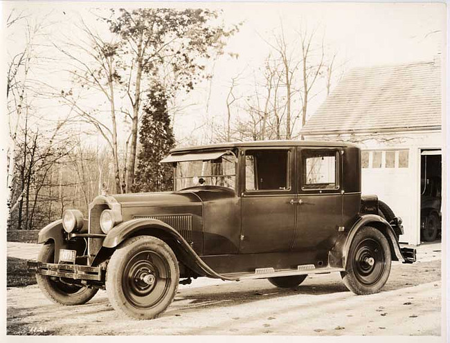 1925-1926 Packard club sedan parked in front of garage