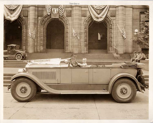 1927 Packard phaeton with Baby Snookums behind wheel in St. Louis, Mo.