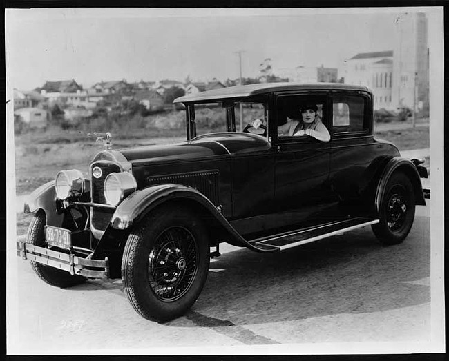 1927 Packard coupe, three-quarter left front view, actress Pauline Starke behind wheel
