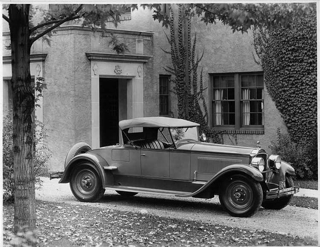 1927 Packard two-toned runabout, five-sixth left front view, top raised, parked in driveway