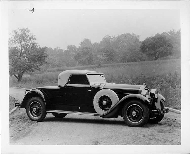 1928 Packard roadster, seven-eights right front view, top raised, parked on country road