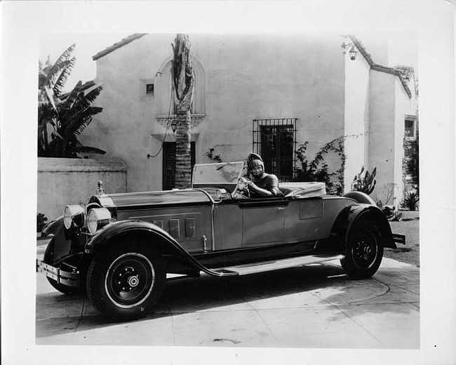 1928 Packard runabout, male dressed in armor behind wheel
