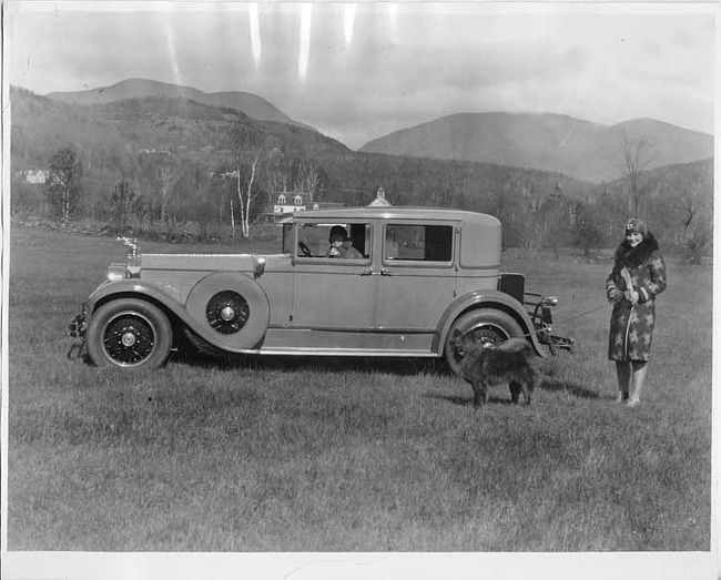 1928 Packard sedan and woman with chow-chow dog on leash