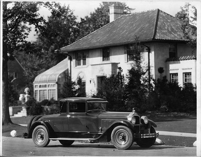 1928 Packard stationary coupe, five-sixths right front view, parked on residential street