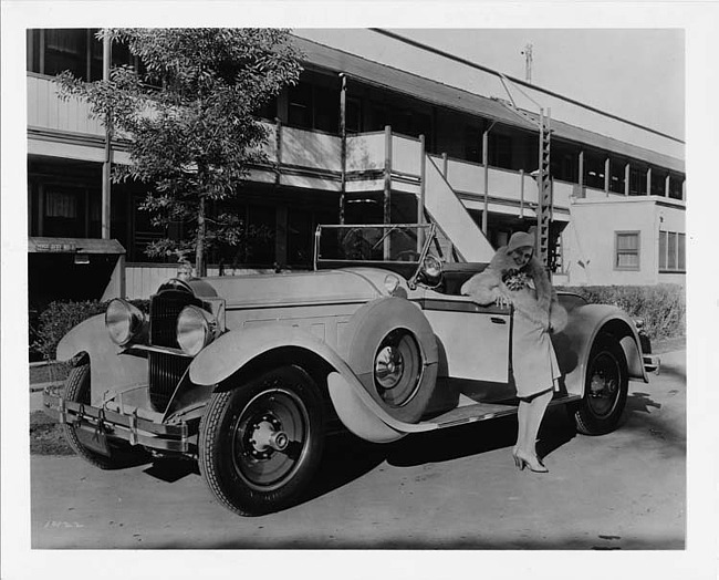 1929 Packard roadster, female standing at driver's door