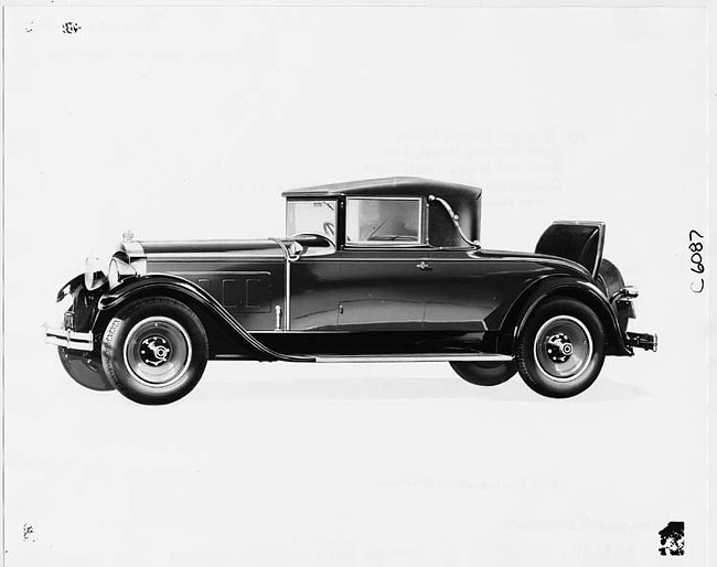 1929 Packard convertible coupe, nine-tenths left front view, top raised, rumble seat open