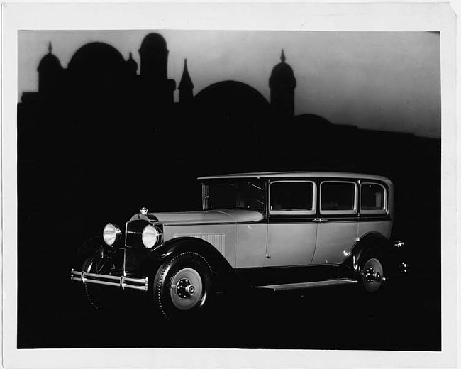 1930 Packard sedan, three-quarter right front view, domed building in background