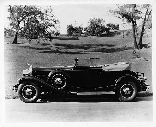 1931 Packard convertible victoria, left side view, top folded, in park setting