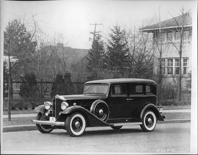 1933 Packard sedan, three-quarter left side view, parked on street