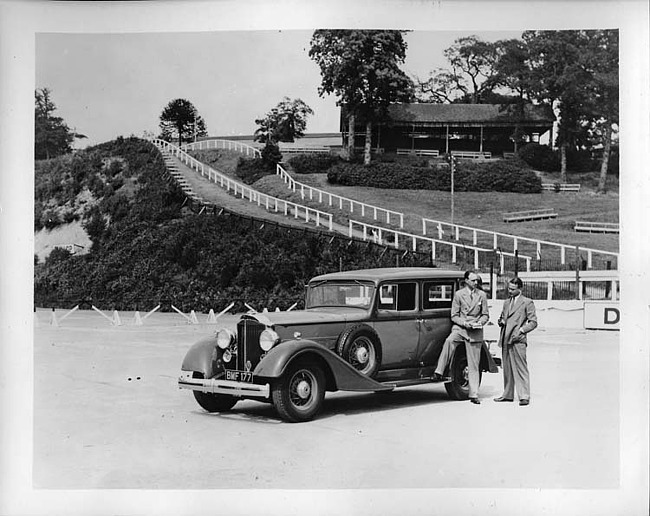 1934 Packard sedan, three-quarter left front view, two men standing at driver's door
