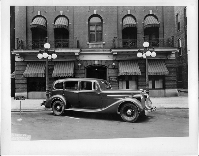 1935 Packard commercial sedan, nine-tenths right side view, parked on city street