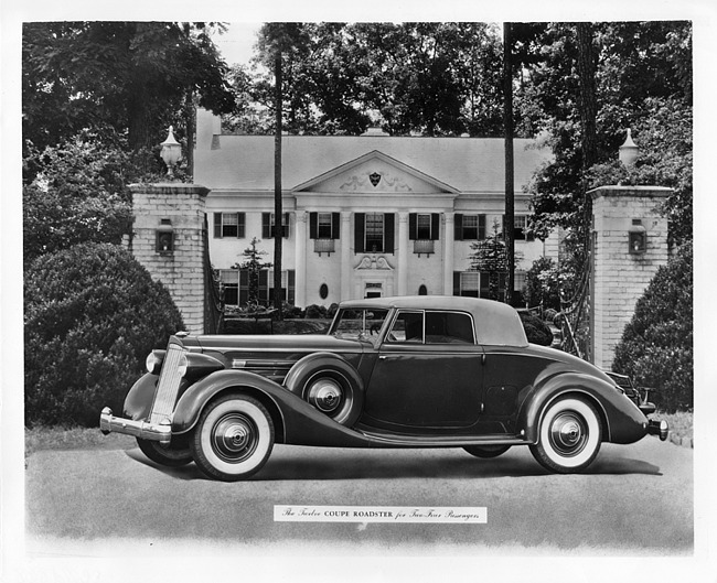 1936 Packard coupe roadster, parked in front of gateway, house in background