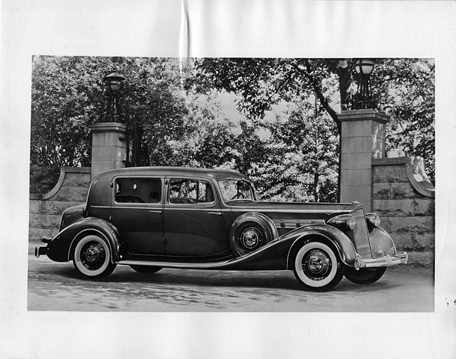 1936 Packard club sedan, nine-tenths right side view, parked in front of stone gateway