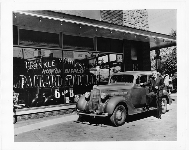 1937 Packard touring sedan, parked in front of Trinkle Motor Sales