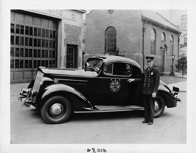 1937 Packard business coupe with fire chief at station