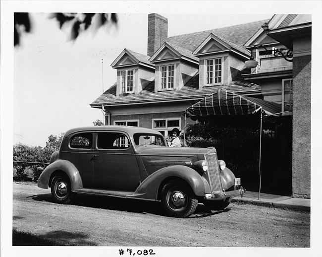 1937 Packard touring coupe parked on street in front of home