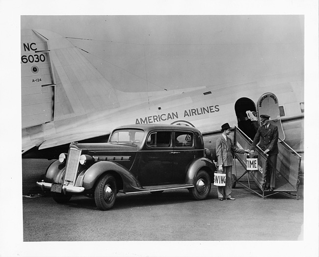 1937 Packard club sedan, parked beside American Airlines plane