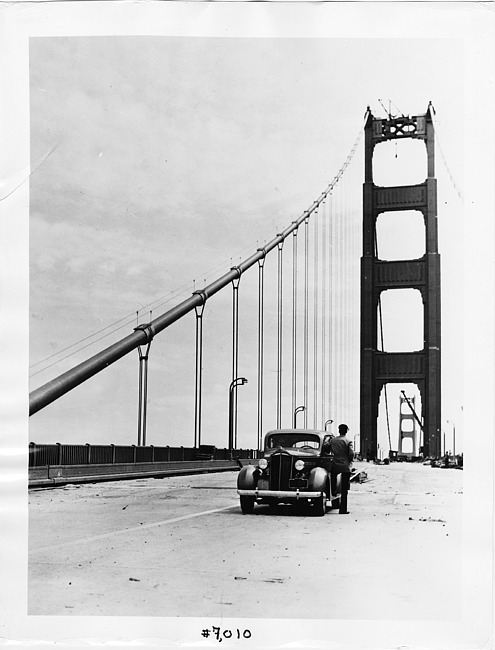1937 Packard sedan, parked on the almost completed Golden Gate Bridge