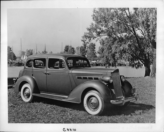 1937 Packard touring sedan, three-quarter right side view, parked on grass