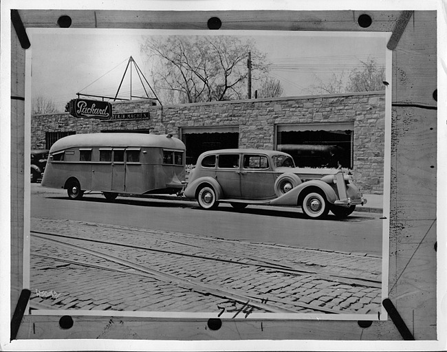 1937 Packard touring sedan in front of Ster & Machen Packard dealership