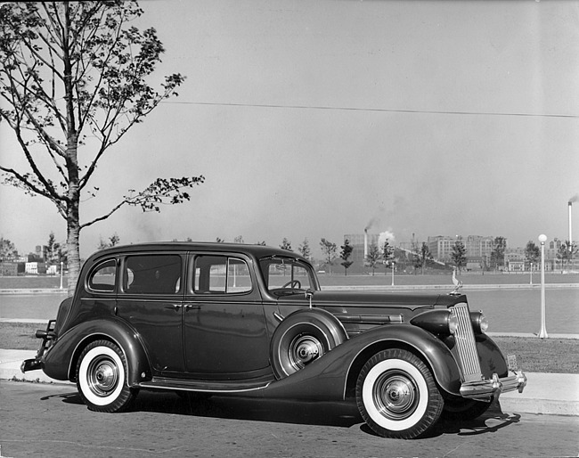 1937 Packard touring sedan, nine-tenths right front view, parked on street