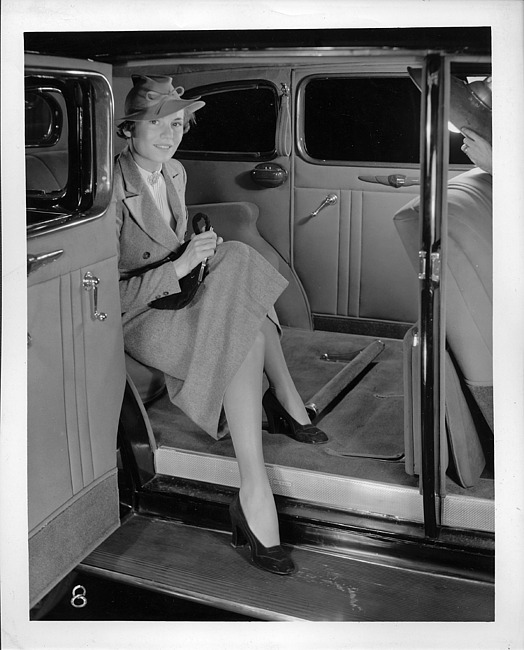 1937 Packard touring sedan, view of rear interior from right, woman stepping out of rear