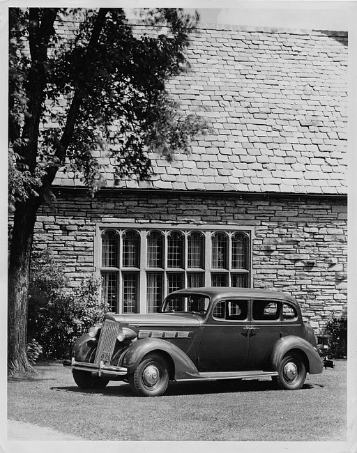 1937 Packard touring sedan, seven-eights right side view, parked on grass