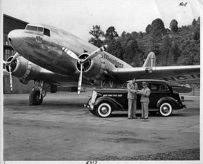1937 Packard touring sedan next to United Air Lines Mainliner airplane