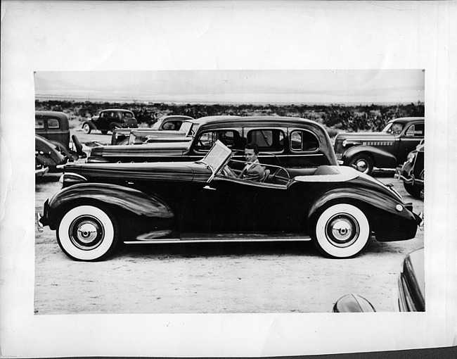 1938 Packard convertible victoria, left side view, top folded, Alvin Macauley, Jr. behind wheel