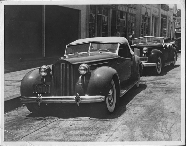 1938 Packard convertible victorias parked on street, front view