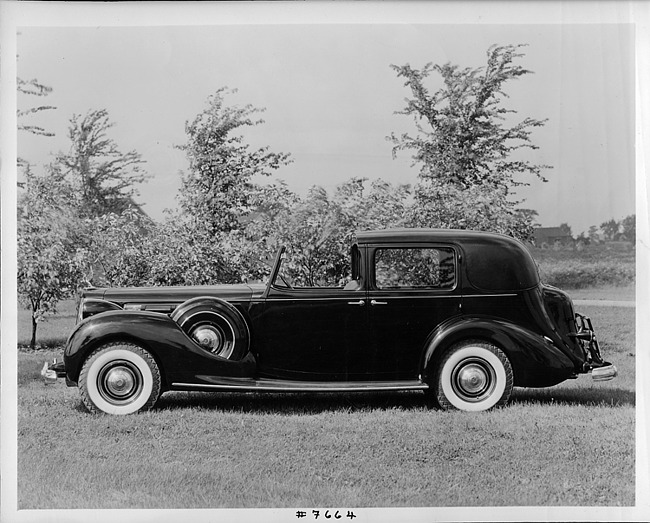 1939 Packard all weather cabriolet, left side view, parked on grass