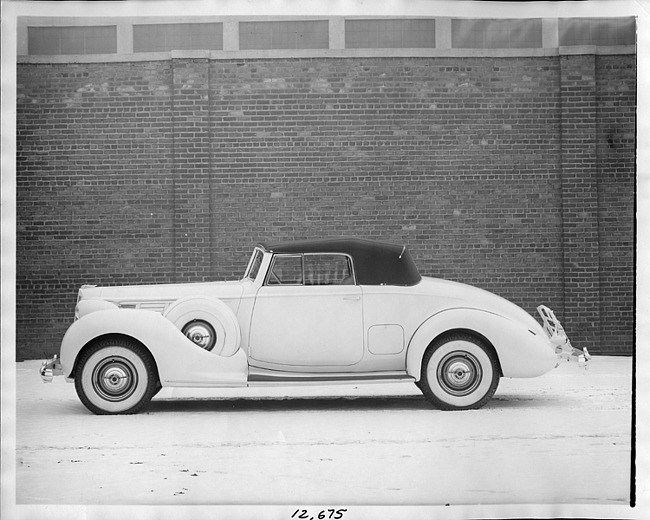 1938 Packard coupe roadster, left side view, top raised, light in color
