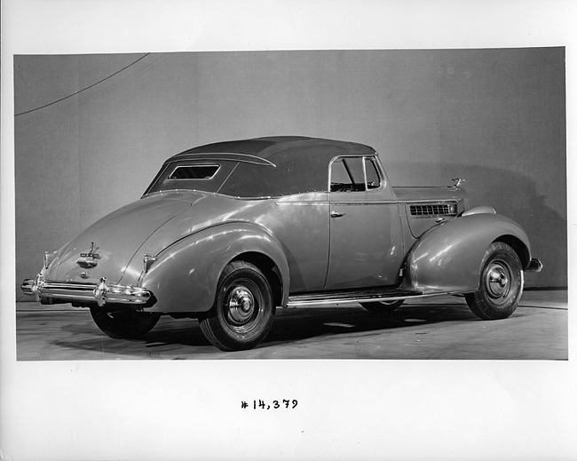 1939 Packard convertible coupe, three-quarter rear view, top raised