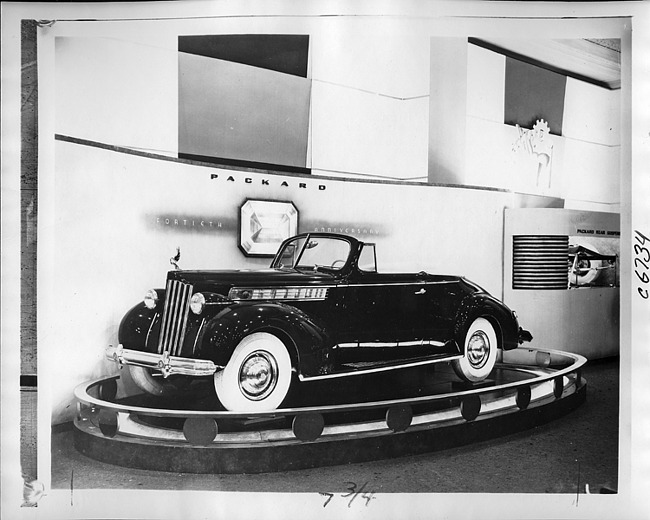 1939 Packard convertible coupe, three-quarter left side view, top folded, on display