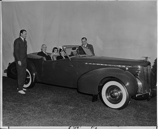 1940 Packard convertible victoria in front of backdrop